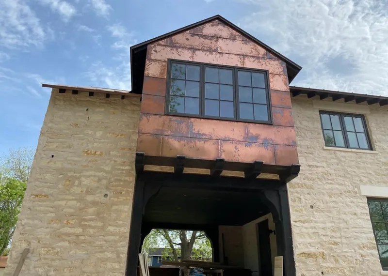 Copper metal panel facade on a stone building for Skylight Installation in Andalusia